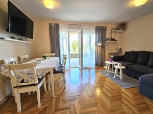 a living room with a table and a couch at Apartments Mirko in Malinska