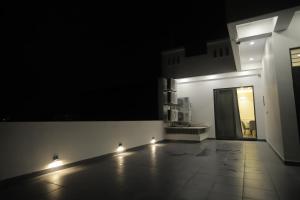 a dark room with a hallway with a door and lights at The Golden Glow by Ivory Stays in Udaipur