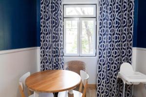 a dining room with a table and a window at Hostel Crespo in Lisbon +34 photos
