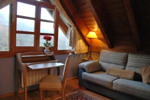 a living room with a couch and a table at Hotel Selba d'Ansils in Benasque