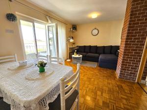 a living room with a table and a couch at Apartments Mirko in Malinska
