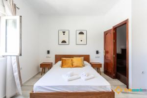 a bedroom with a bed with two towels on it at Torre Argantonio by LiveWork in Cádiz