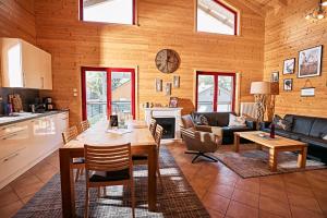 a kitchen and living room with a wooden wall at EifelGlückVII in Rieden