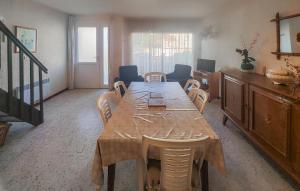 a dining room with a wooden table and chairs at 4 Bedroom Nice Home In Agde in Le Grau-dʼAgde