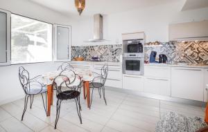 a kitchen with a table and chairs in it at 3 Bedroom Stunning Home In Talasani in Talasani