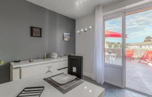 a room with a desk with a television and a balcony at 1 Bedroom Stunning Apartment In Médis in Médis