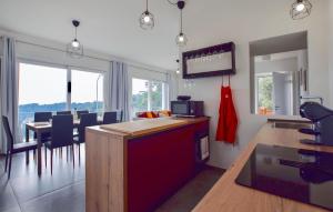 a kitchen and dining room with a table and chairs at Splendida Casa In Corsanico in Massarosa