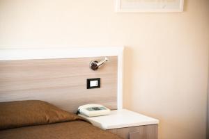 Ein Bett oder Betten in einem Zimmer der Unterkunft Hotel Fabricia