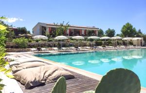 a large swimming pool with lounge chairs and umbrellas at Gorgeous Home In Vieste in Vieste