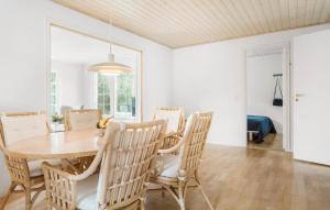 a dining room with a wooden table and chairs at 3 Bedroom Cozy Home In Hørve in Hørve