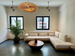 a living room with a couch and a table at Rea Boutique Apartments in Agia Galini