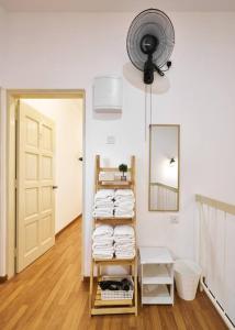 a room with a towel rack with a mirror and a fan at Ipoh South Homestay 8-16pax 10mins to attraction in Ipoh