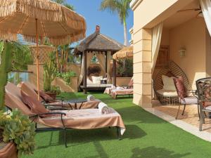 an outdoor patio with chairs and a gazebo at Royal Garden Villas, Luxury Hotel in Adeje