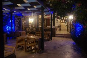 a restaurant with tables and chairs and blue lights at B&B Boutique Hotel in Dalyan