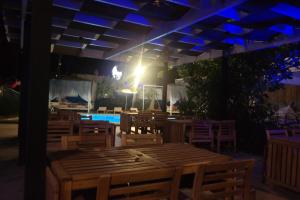 a restaurant with wooden tables and chairs at night at B&B Boutique Hotel in Dalyan