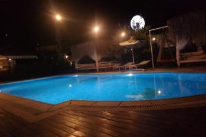a large blue swimming pool at night at B&B Boutique Hotel in Dalyan
