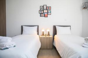 two beds sitting next to each other in a bedroom at Koni Villa Paphos in Paphos City +35 photos