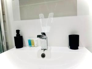 a white counter top with a blow dryer on it at Cozy Fully Equipped Loft Studio City Centre in Maidstone +13 photos