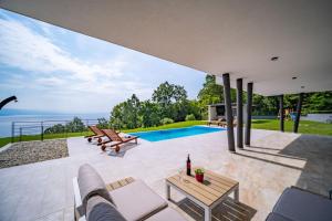 a house with a view of a swimming pool at Villa Deavista by Villsy in Matulji