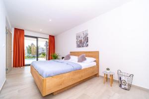 a bedroom with a bed and a large window at Villa Deavista by Villsy in Matulji +47 photos