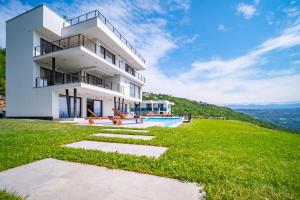 a house on top of a hill with a swimming pool at Villa Deavista by Villsy in Matulji