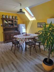 a dining room with a table and chairs and a plant at Apartment Balatonboglar 7 in Balatonboglár