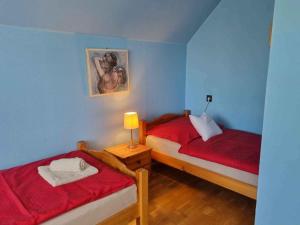 a bedroom with two beds and a painting on the wall at Apartment Balatonboglar 7 in Balatonboglár +29 photos