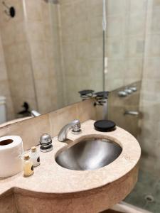 a bathroom with a sink and a shower with a mirror at Hotel Cuesta del Viento in San Juan +29 photos