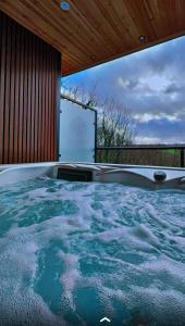 a bath tub with a view of the water at Woodroyd apartments in Luddenden Foot