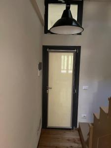 a door in a room with a light and a lamp at Casa Gastone in Rimini +7 photos