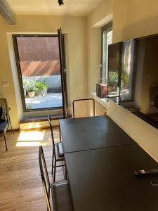 a dining room with a table and chairs and a window at Casa Gastone in Rimini