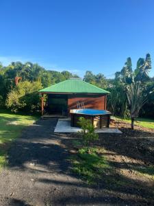 a pavilion with a picnic table in a park at Verdure et nature in Émilien