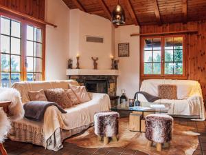 a living room with a couch and a fireplace at Chalet La Couronne by Interhome in Nendaz
