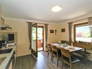 Una cocina y un comedor con mesa y sillas. en Apartment Paradiso by Interhome, en Ramsau