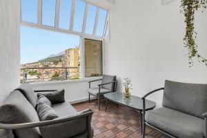 a living room with a couch and a table and a window at Apartment Sanja Makarska Center in Makarska