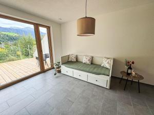 a room with a couch and a table and a window at Apartment Urgen Living by Interhome in Fliess