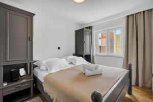 a bedroom with a large bed with white pillows at Apartment Sanja Makarska Center in Makarska
