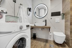 a laundry room with a washing machine and a mirror at Apartment Sanja Makarska Center in Makarska +26 photos