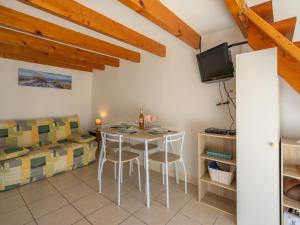 a dining room with a table and chairs and a tv at Studio Nauzan by Interhome in Saint-Palais-sur-Mer