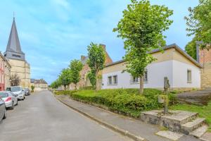 a street in a small town with a church at Sixties Forever - une immersion années 60 in Aubenton