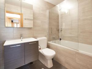 a bathroom with a toilet and a sink and a tub at Chalet Fuchsia by Interhome in Les Collons