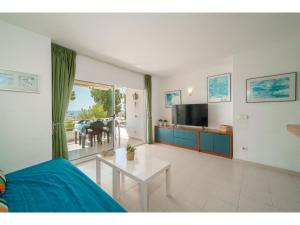 a living room with a bed and a table at Apartment Xisca by Interhome in Port d'Alcudia +11 photos
