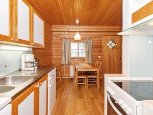 a kitchen and dining room with a table at Holiday Home Kulta-käkönen 10 by bomba by Interhome in Nurmes +11 photos