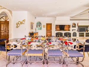 a room with chairs and a table with food on it at Holiday Home La Bonne Nouvelle by Interhome in Méounes-lès-Montrieux