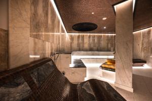 a room with a bench and a table at Santé SPA Hotel in Velingrad