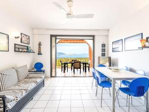 a living room with a couch and a table and chairs at Apartment Casa Giulia II by Interhome in Lumio