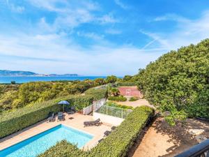 an ocean view from the balcony of a house with a swimming pool at Apartment Casa Giulia II by Interhome in Lumio