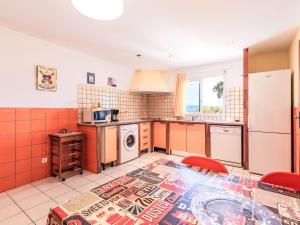 a kitchen with orange and white tiled walls at Apartment Casa Giulia I by Interhome in Lumio