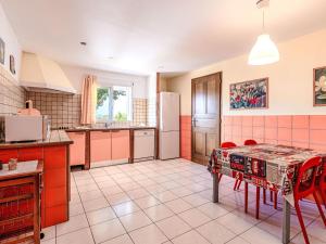 a kitchen with a table and red chairs in it at Apartment Casa Giulia I by Interhome in Lumio +17 photos