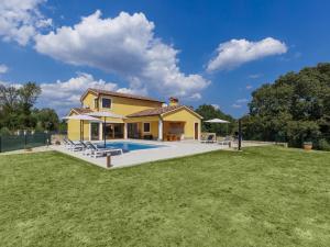 a house with a pool and a yard at Holiday Home Villa Ana Lucija by Interhome in Labin